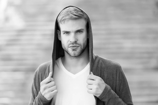 Perfect male. Fashionable young model man. man posing with hoodie. young street man with hood. Incognito Boy. handsome man with hood standing in urban city interior. informal style clothing - Fotoğraf, Görsel
