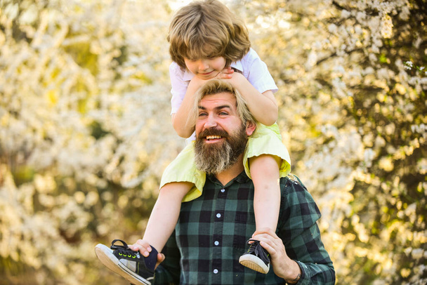 Happy family. Fatherhood happiness. Fathers day. Earth day. Little boy and father in nature background. Hipster and baby son. Happiness concept. Spring walk. Ecology and environment. Simple happiness - Φωτογραφία, εικόνα