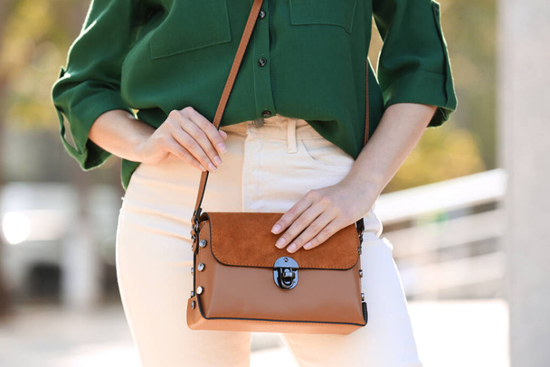 Young woman with stylish leather bag outdoors on summer day, closeup - Foto, Imagem