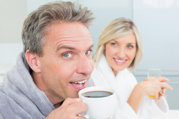 Happy couple in bathrobes with coffee cup and juice - Φωτογραφία, εικόνα