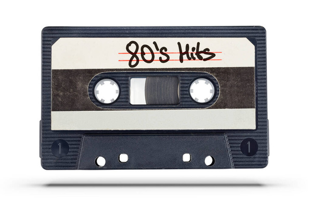 Audio record. Old tape compact cassette with 80's hits text isolated on white background  - Zdjęcie, obraz