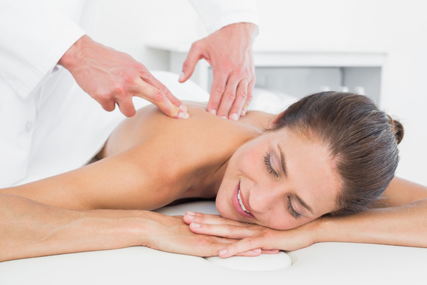 Male physiotherapist massaging woman's back - Fotó, kép