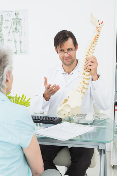 Male doctor explaining the spine to a patient - Photo, image