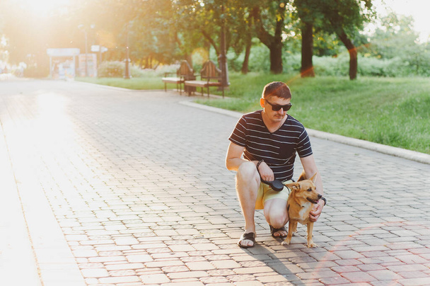 Man is smile fun with their dog labrador retriever outdoors. Making selfie. Concept friendship - Фото, зображення