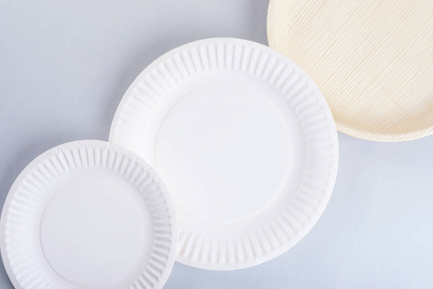 Disposable plates lined up diagonally on a photo - Photo, Image