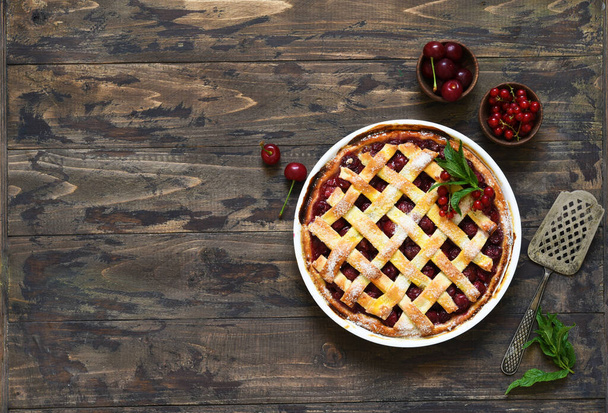 Cherry pie on a wooden background with place for text. View from above. - Foto, immagini