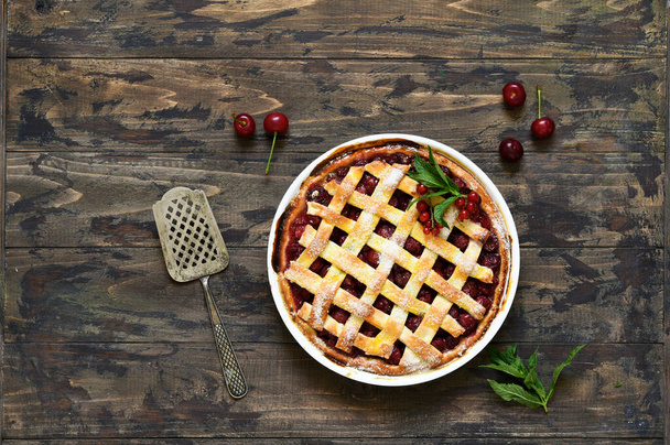 Cherry pie on a wooden background with place for text. View from above. - Fotó, kép