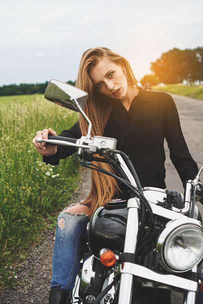 Portrait of red haired girl biker on a motorcycle. - Φωτογραφία, εικόνα