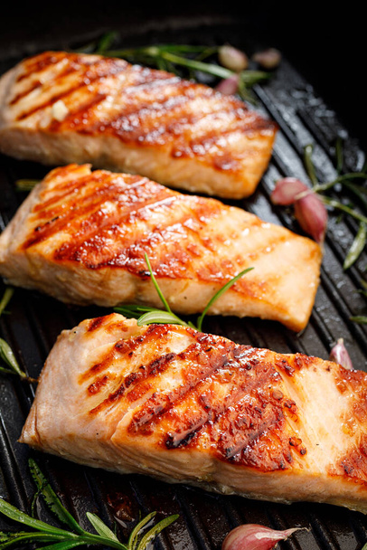 Grilled salmon fillets on a grill plate close up  view - Photo, Image