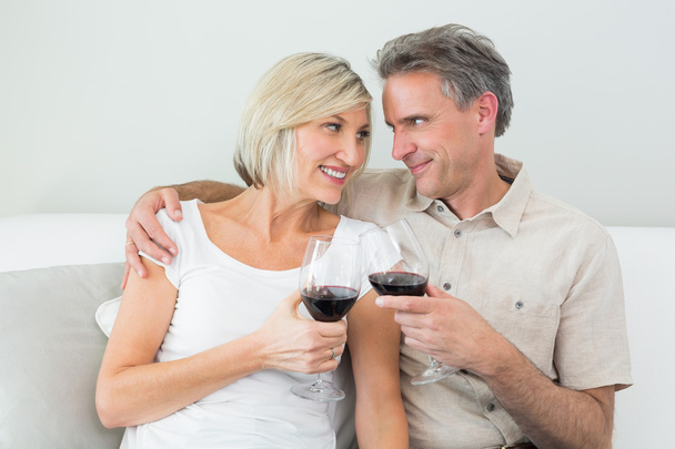 Couple toasting wine glasses at home - Foto, afbeelding