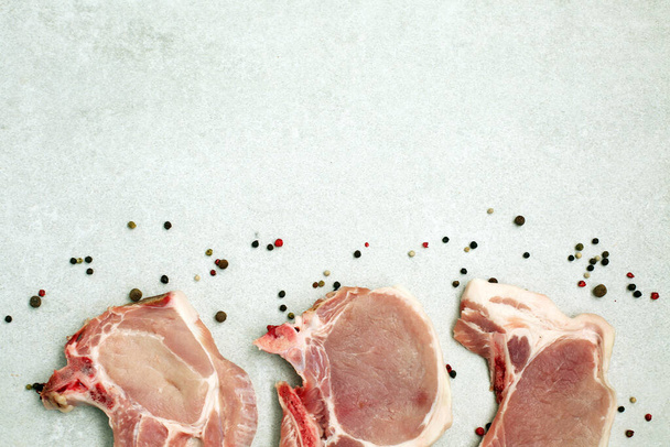 Raw pork steak on bone on light background. - Φωτογραφία, εικόνα