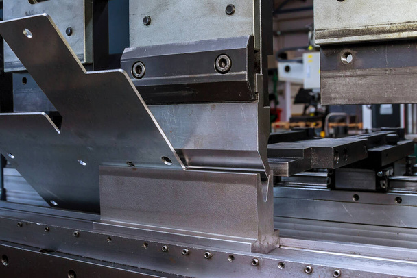 Bending sheet metal with a hydraulic bending machine at the factory. - Photo, Image