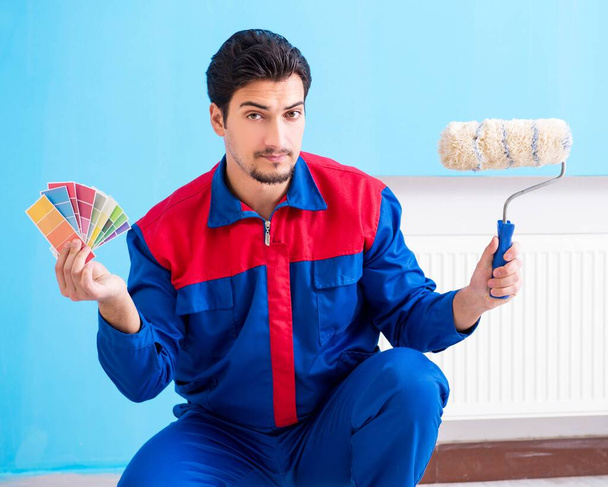 Young man contractor choosing color from rainbow - Photo, Image