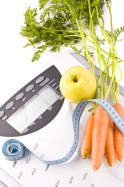 Carrots, apple and measuring objects - Foto, imagen
