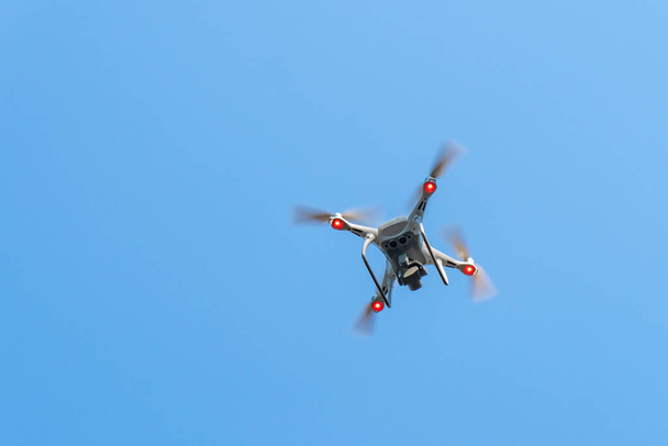 Flying drone with blue sky background, new technology - Photo, Image