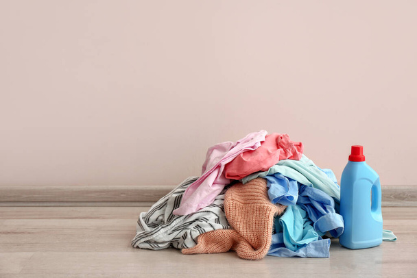 Βρώμικα ρούχα στο πάτωμα κοντά σε ανοιχτό τοίχο - Φωτογραφία, εικόνα