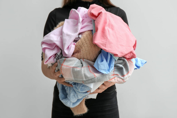Woman with dirty clothes on light background - Photo, Image