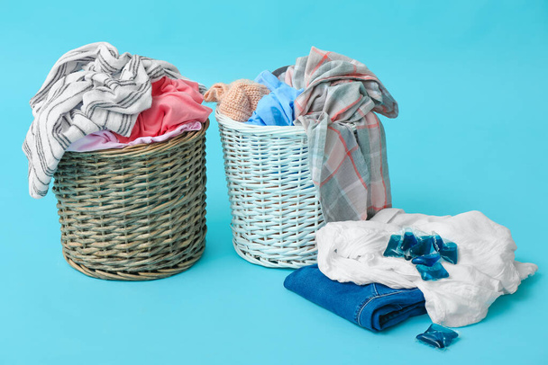 Baskets with dirty clothes on color background - Photo, Image