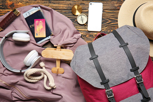 Set of traveler's accessories on wooden background - Foto, afbeelding