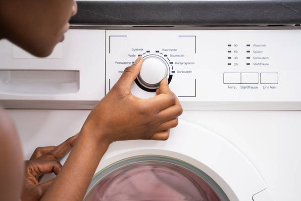 Person Hand Setting Washing Machine For Clothes Laundry - Fotó, kép