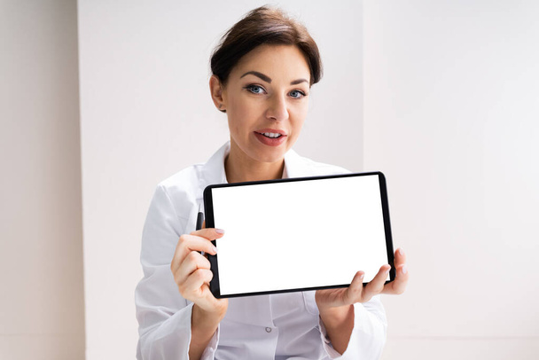 Female Doctor Holding Tablet Computer With Empty Screen - Photo, Image