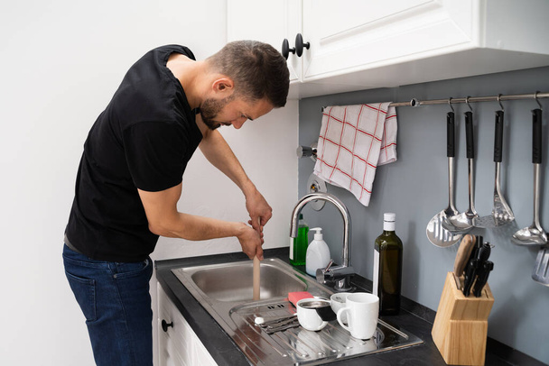 Cleaning Blocked Drain Clog In Kitchen Sink Using Plunger - Фото, зображення
