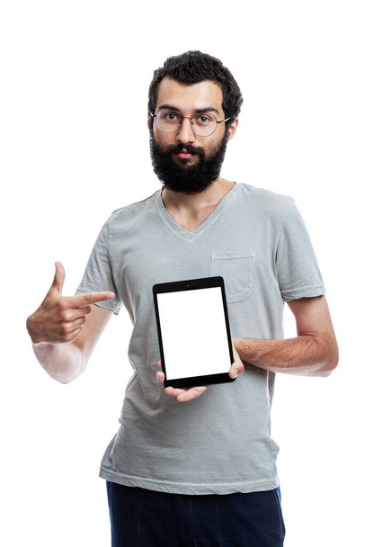 A young man with a tablet shows on an isolated screen. Space for text. White background. Vertical. Mockup - Fotó, kép