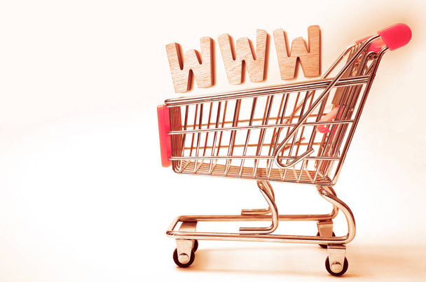 shopping cart basket isolated on white background. Buying domain name for company website.Online shopping, e commerce and internet store concept. Newsletter and email marketing. www letters - Foto, Imagen