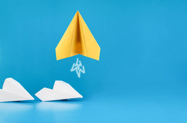  one yellow paper airplane takes off on a blue background - 写真・画像