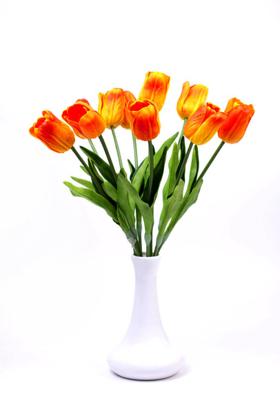 Bouquet of orange-red tulips on a white background in a vase - Photo, image