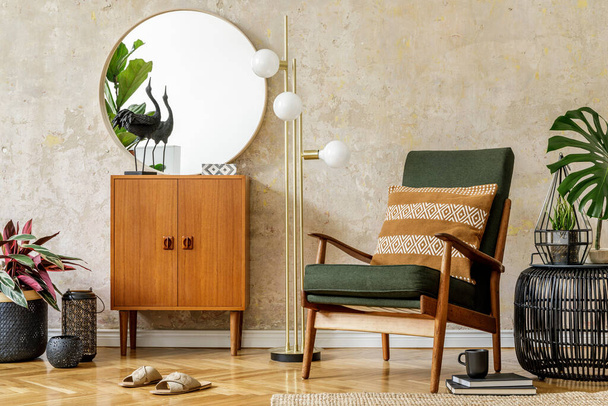Modern retro composition of living room interior with vintage armchair, lamp, commode, tropical leaf, plant, decoration, round mirror and elegant presonal accessories in wabi sabi concept. - Fotografie, Obrázek