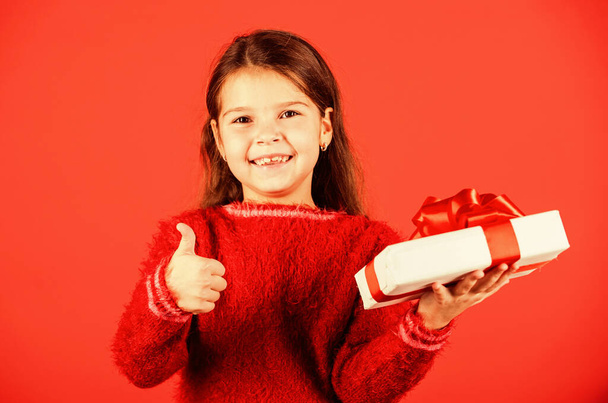 Boxing day. Small girl hold gift box. Kid hold present box red background. Shop store mall. Birthday girl. Merry Christmas and happy holidays. Xmas gift shopping. Gift package. Cherished dreams - Fotoğraf, Görsel