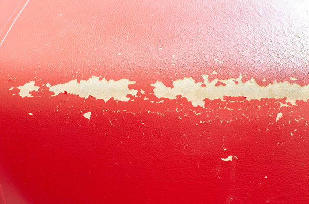 Damaged leather texture on the upholstery of the sofa and furniture. Restoration and repair, red leather, background - Fotoğraf, Görsel