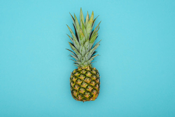 top view of ripe pineapple on blue background - Fotó, kép