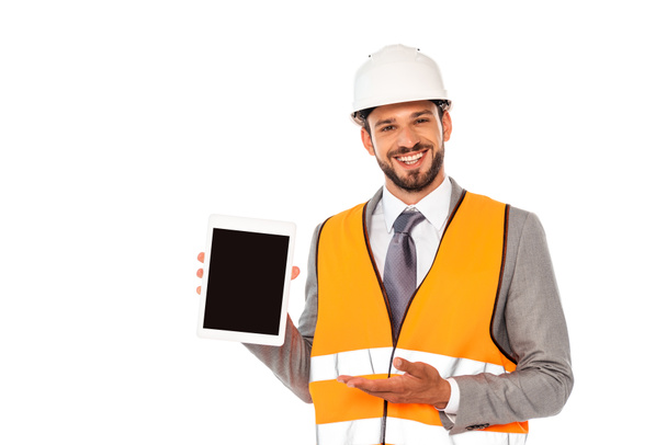Smiling engineer pointing with hand at digital tablet with blank screen isolated on white - Fotó, kép