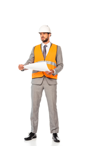 Handsome engineer in suit and hardhat holding blueprint on white background - Foto, immagini