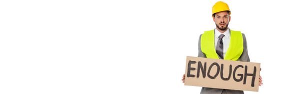 Panoramic shot of engineer holding signboard with enough lettering isolated on white - Photo, Image