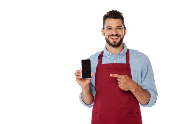 Positive waiter pointing with finger at smartphone with blank screen isolated on white - 写真・画像