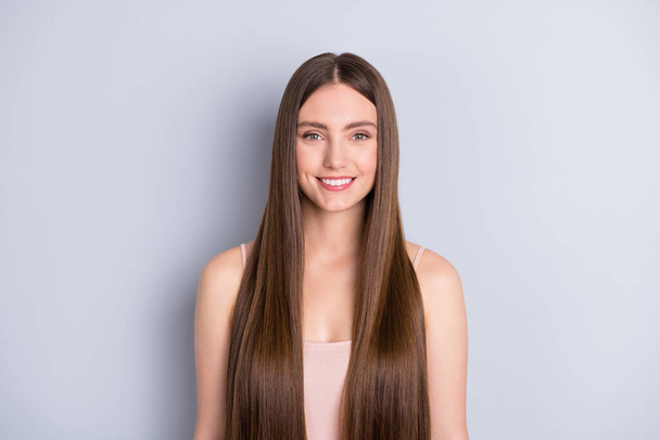 Photo of attractive cute perfect appearance model lady beaming smile demonstrating ideal neat long healthy hairstyle after salon wear beige singlet isolated grey color background - Φωτογραφία, εικόνα
