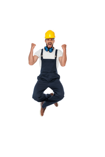 Excited builder in uniform showing yeah gesture isolated on white - Photo, Image