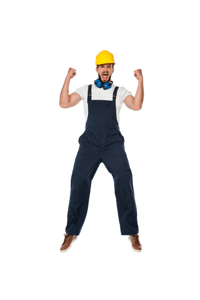 Excited builder in workwear and hardhat showing yes gesture isolated on white - Photo, Image