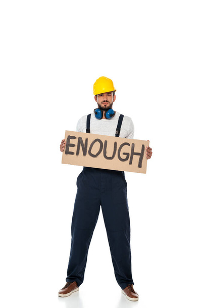 Handsome builder in uniform holding signboard with enough lettering on white background - Photo, Image