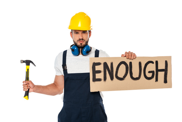 Angry builder holding signboard with enough lettering and hammer isolated on white - Photo, Image
