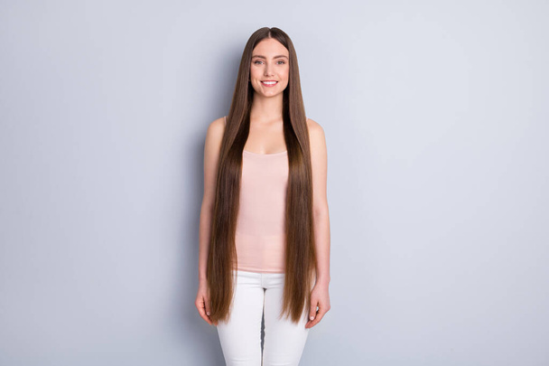 Photo of charming perfect appearance model lady toothy smiling demonstrating ideal neat long hairstyle wear beige singlet white trousers isolated grey color background - Foto, Imagen