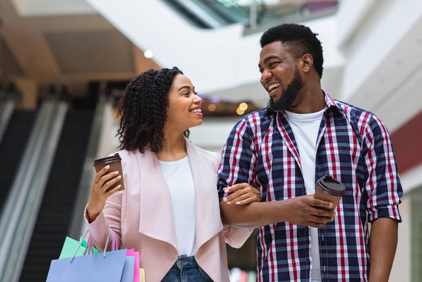 Loving black couple shopping at the mall and drinking takeaway coffee - Photo, Image