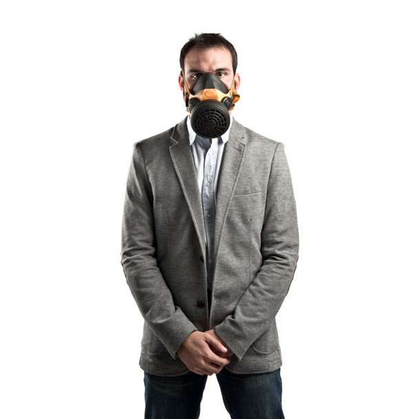 young businessman with gas mask over white background - Foto, Imagem
