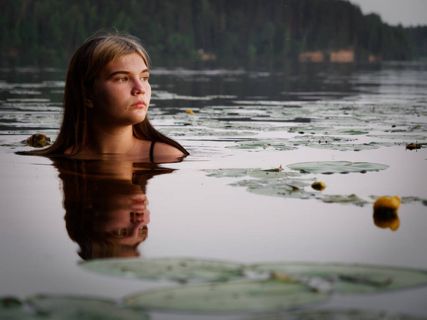 sereia menina na água entre lírios de água no por do sol 2020
 - Foto, Imagem