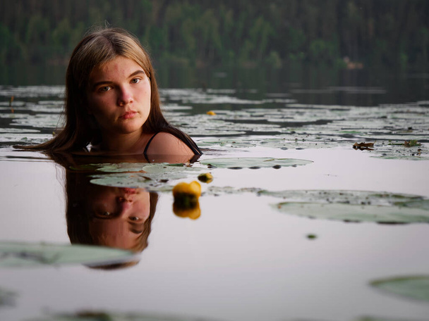sereia menina na água entre lírios de água no por do sol 2020
 - Foto, Imagem