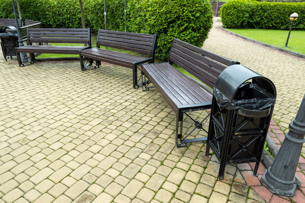 wooden seats with metal legs in landscaping - Photo, Image
