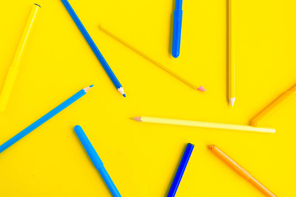 Color pencils on bright yellow background, education concept - Photo, Image